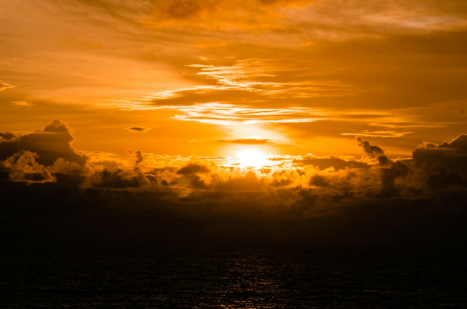Tanah Lot sea temple silhouetted against an orange Bali sunset