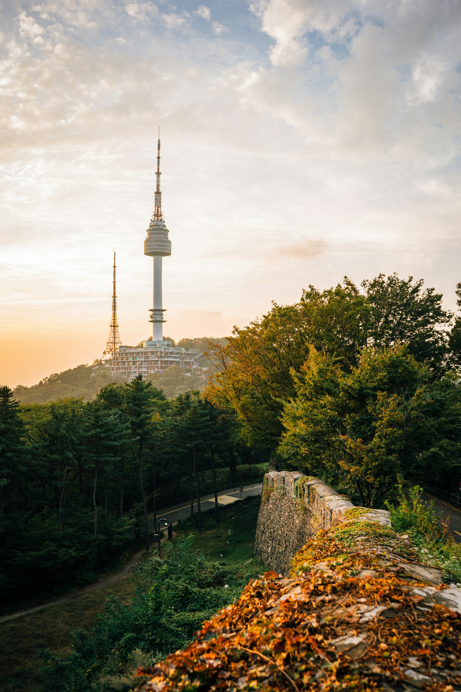 Cable car ascending Namsan Mountain toward N Seoul Tower with the Seoul skyline behind it