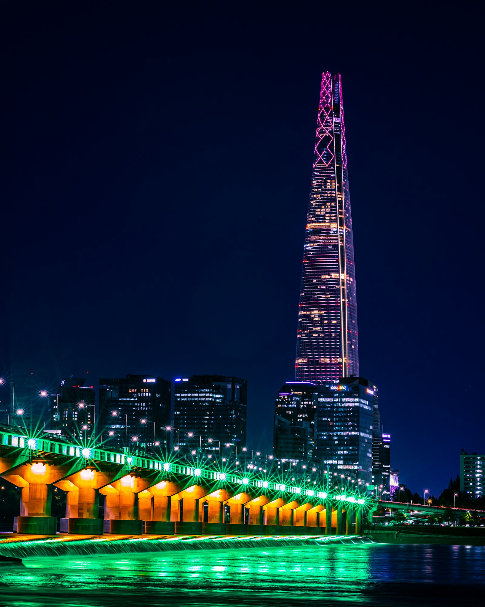 Han River bridge lit up at night in Seoul near Banpo